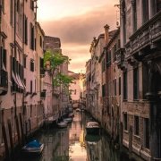 Tourism in Venice – sunset reflected in the channel water Tourism in Venice - sunset reflected in the channel water