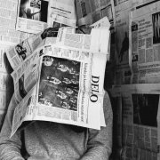 Man under newspapers Man under newspapers