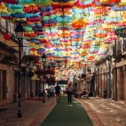 Street in Portugal with umbrellas covering the footpath Street in Portugal with umbrellas covering the footpath