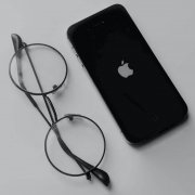 Steve Jobs eye glasses next to an iPhone Steve Jobs eye glasses next to an iPhone