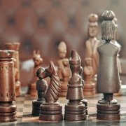 Game of strategy: chess pieces on the table Game of strategy: chess pieces on the table