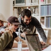 Social media effect: people laughing and pointing at laptop screen Social media effect: people laughing and pointing at laptop screen