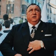 Man wearing an expensive black suit being shocked or suprised in a crowd of church choir children Man wearing an expensive black suit being shocked or suprised in a crowd of church choir children