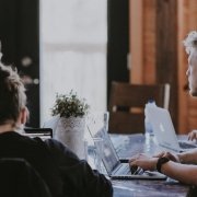 Business partners Business partners discussing as a team around the table